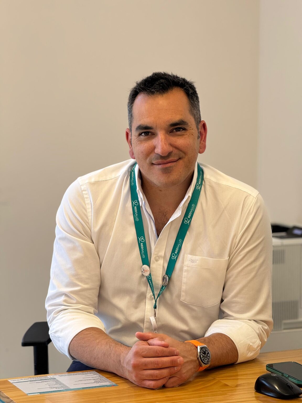 Cirujano bariátrico Jaime Zamarin sonriendo sentado en su escritorio de consulta médica.